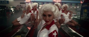 Movie still from “Southland Tales” (2006), directed by Richard Kelly – A group of women dressed as nurses in front of a mirror; Medium shot, Low angle