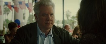 Movie still from “Southland Tales” (2006), directed by Richard Kelly – An older man in a green jacket looks at the camera; Close Up shot, Over the shoulder angle