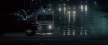 Movie still from “Southland Tales” (2006), directed by Richard Kelly – A police car driving down a street at night; Extreme Wide shot, High angle