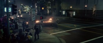 Movie still from “Southland Tales” (2006), directed by Richard Kelly – A police officer directing traffic on a street at night; Extreme Wide shot, High angle