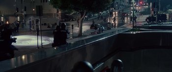 Movie still from “Southland Tales” (2006), directed by Richard Kelly – A group of people on a motorcycle on a city street at night; Extreme Wide shot, High angle
