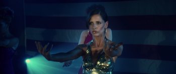 Movie still from “Southland Tales” (2006), directed by Richard Kelly – A beautiful woman in a silver dress is dancing; Medium shot, Over the shoulder angle