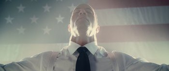 Movie still from “Southland Tales” (2006), directed by Richard Kelly – A man in a white shirt and a black neck tie; Close Up shot, Low angle