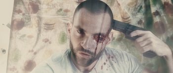 Movie still from “Southland Tales” (2006), directed by Richard Kelly – A person with blood on his face; Extreme Close Up shot, Overhead angle