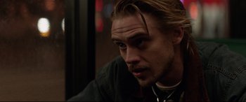 Movie still from “A Walk Among the Tombstones” (2014), directed by Scott Frank – A person with long blonde hair; Close Up shot, Over the shoulder angle