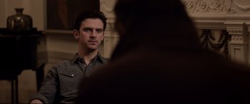 Movie still from “A Walk Among the Tombstones” (2014), directed by Scott Frank – A man standing in front of a mirror looking at himself in the mirror; Close Up shot, Over the shoulder angle