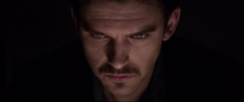 Movie still from “A Walk Among the Tombstones” (2014), directed by Scott Frank – A person with a mustache; Close Up shot, Over the shoulder angle