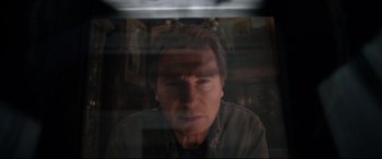 Movie still from “A Walk Among the Tombstones” (2014), directed by Scott Frank – A man is looking through a window at the camera; Close Up shot, Low angle