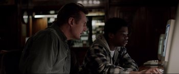 Movie still from “A Walk Among the Tombstones” (2014), directed by Scott Frank – Two men sitting at a table in front of each other; Medium shot, Over the shoulder angle
