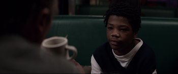 Movie still from “A Walk Among the Tombstones” (2014), directed by Scott Frank – A person sitting in front of a coffee mug; Close Up shot, Over the shoulder angle