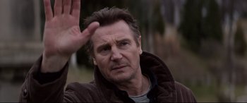 Movie still from “A Walk Among the Tombstones” (2014), directed by Scott Frank – A person holding his hand up; Close Up shot, Over the shoulder angle