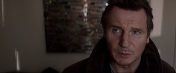 Movie still from “A Walk Among the Tombstones” (2014), directed by Scott Frank – A person wearing a jacket; Close Up shot, Over the shoulder angle