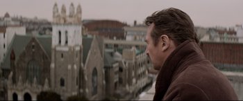 Movie still from “A Walk Among the Tombstones” (2014), directed by Scott Frank – A person looking out over a city; Close Up shot, Low angle