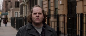 Movie still from “A Walk Among the Tombstones” (2014), directed by Scott Frank – A person with long hair; Close Up shot, Over the shoulder angle