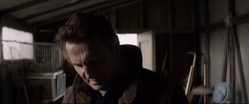 Movie still from “A Walk Among the Tombstones” (2014), directed by Scott Frank – A person wearing a suit and tie; Close Up shot, Low angle