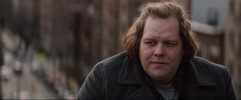 Movie still from “A Walk Among the Tombstones” (2014), directed by Scott Frank – A person with long hair; Close Up shot, Over the shoulder angle