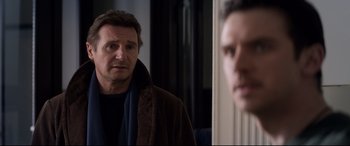 Movie still from “A Walk Among the Tombstones” (2014), directed by Scott Frank – A man standing in front of a mirror looking at himself in the mirror; Close Up shot, Over the shoulder angle
