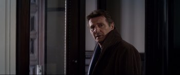 Movie still from “A Walk Among the Tombstones” (2014), directed by Scott Frank – A person wearing a coat and a tie; Close Up shot, Over the shoulder angle