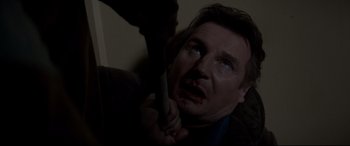 Movie still from “A Walk Among the Tombstones” (2014), directed by Scott Frank – A man with blood on his face holding a knife; Close Up shot, Low angle