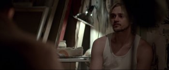 Movie still from “A Walk Among the Tombstones” (2014), directed by Scott Frank – A man sitting at a table in front of a mirror; Close Up shot, Over the shoulder angle