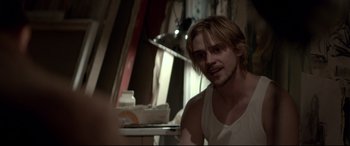 Movie still from “A Walk Among the Tombstones” (2014), directed by Scott Frank – A person sitting in a room; Medium shot, Over the shoulder angle