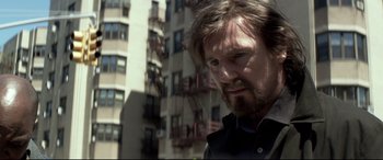 Movie still from “A Walk Among the Tombstones” (2014), directed by Scott Frank – A person with a beard; Close Up shot, Low angle