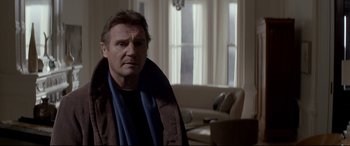 Movie still from “A Walk Among the Tombstones” (2014), directed by Scott Frank – A man in a brown jacket and a blue scarf; Medium shot, Over the shoulder angle
