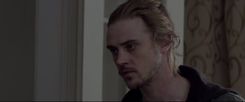 Movie still from “A Walk Among the Tombstones” (2014), directed by Scott Frank – A person with long blonde hair; Close Up shot, Over the shoulder angle