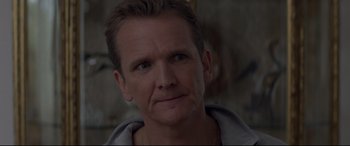 Movie still from “A Walk Among the Tombstones” (2014), directed by Scott Frank – A person wearing a hoodie; Close Up shot, Over the shoulder angle