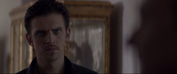 Movie still from “A Walk Among the Tombstones” (2014), directed by Scott Frank – A person in a room with a mirror; Close Up shot, Over the shoulder angle