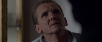 Movie still from “A Walk Among the Tombstones” (2014), directed by Scott Frank – A person looking up at the sky; Close Up shot, Over the shoulder angle