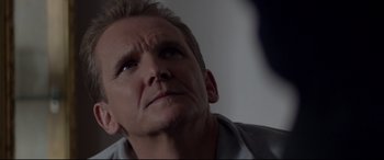Movie still from “A Walk Among the Tombstones” (2014), directed by Scott Frank – A person looking up at the sky; Close Up shot, Over the shoulder angle