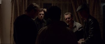 Movie still from “A Walk Among the Tombstones” (2014), directed by Scott Frank – A group of men standing in front of a mirror; Medium shot, Over the shoulder angle