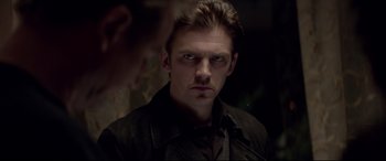 Movie still from “A Walk Among the Tombstones” (2014), directed by Scott Frank – A young man stares into the camera in front of a mirror; Close Up shot, Over the shoulder angle