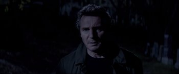 Movie still from “A Walk Among the Tombstones” (2014), directed by Scott Frank – A person wearing a black shirt; Close Up shot, Over the shoulder angle