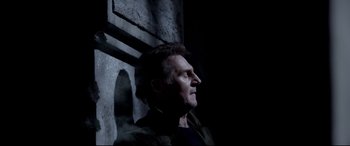 Movie still from “A Walk Among the Tombstones” (2014), directed by Scott Frank – A man in a dark room looking up at the sky; Close Up shot, Low angle