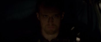 Movie still from “A Walk Among the Tombstones” (2014), directed by Scott Frank – A person's face in the dark; Close Up shot, Low angle