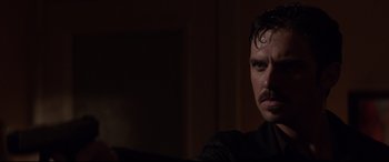 Movie still from “A Walk Among the Tombstones” (2014), directed by Scott Frank – A person with a mustache; Close Up shot, Over the shoulder angle