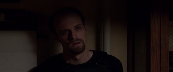 Movie still from “A Walk Among the Tombstones” (2014), directed by Scott Frank – A person wearing a black shirt; Close Up shot, Over the shoulder angle