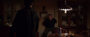 Two men are sitting in a dark room
