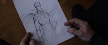 Movie still from “A Walk Among the Tombstones” (2014), directed by Scott Frank – A person holding a drawing of a man holding a sword; Close Up shot, Over the shoulder angle