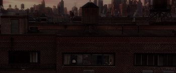 Movie still from “A Walk Among the Tombstones” (2014), directed by Scott Frank – A view of a city from a window of a brick building; Extreme Wide shot, High angle