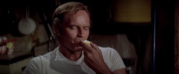 Movie still from “Soylent Green” (1973), directed by Richard Fleischer – A person eating a piece of food; Close Up shot, Low angle