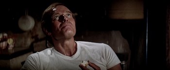 Movie still from “Soylent Green” (1973), directed by Richard Fleischer – A person holding a piece of food; Close Up shot, Low angle