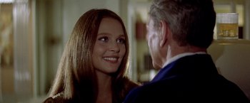 Movie still from “Soylent Green” (1973), directed by Richard Fleischer – A young woman smiling at a man in a suit; Close Up shot, Over the shoulder angle