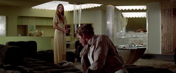 Movie still from “Soylent Green” (1973), directed by Richard Fleischer – A man and a woman are in a room; Wide shot, Over the shoulder angle