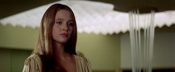 Movie still from “Soylent Green” (1973), directed by Richard Fleischer – A woman with long brown hair standing in a room; Close Up shot, Low angle