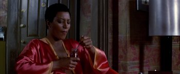 Movie still from “Soylent Green” (1973), directed by Richard Fleischer – A woman sitting in a chair holding a jar of jam; Medium shot, High angle