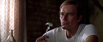 Movie still from “Soylent Green” (1973), directed by Richard Fleischer – A person holding a fork with a leaf on it; Close Up shot, Low angle