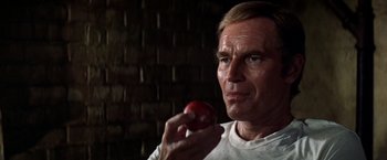 Movie still from “Soylent Green” (1973), directed by Richard Fleischer – A person holding an apple; Close Up shot, Low angle